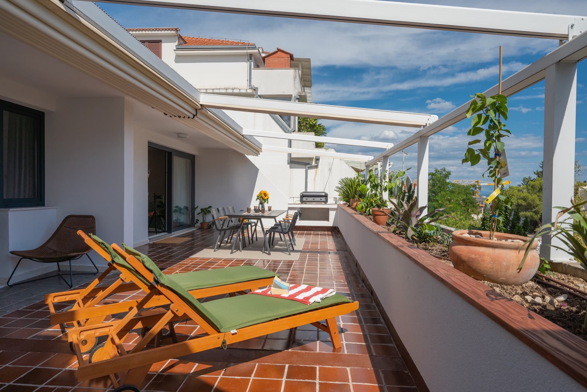 Terrace plants with a glimpse of the sea beyond Split